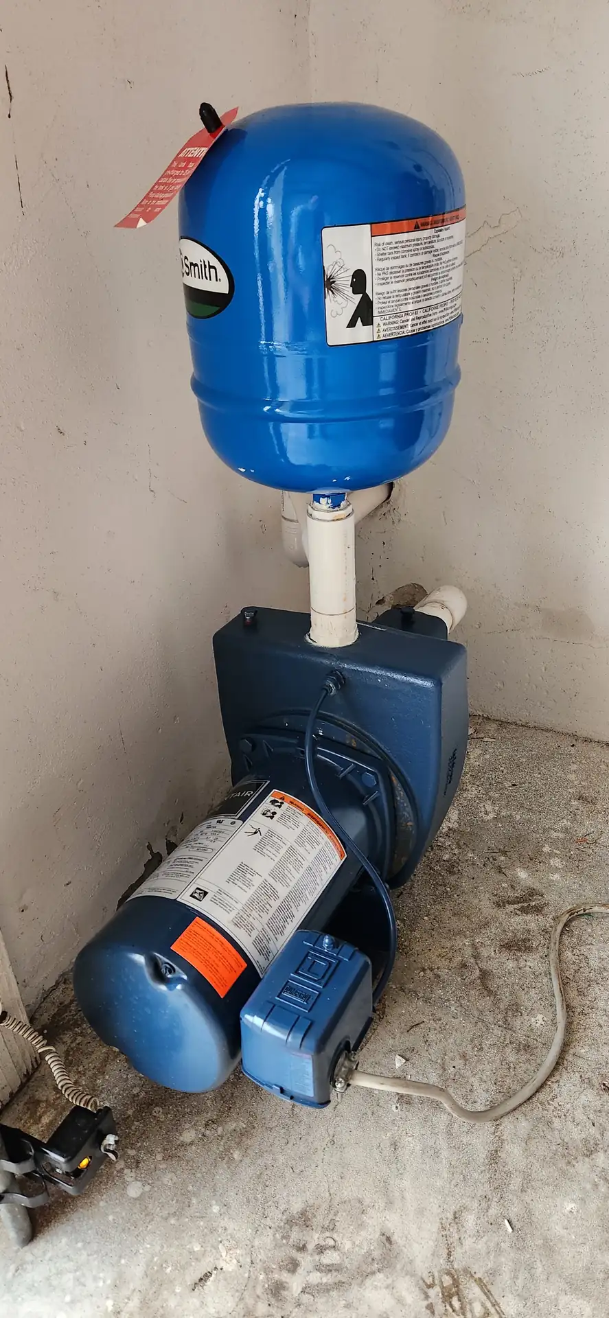 Irrigation well pump and blue pressure tank