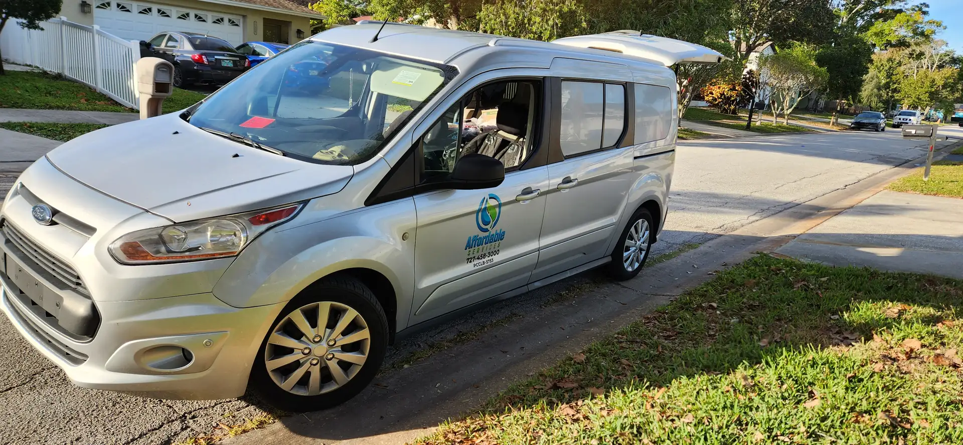 Affordable Sprinklers service van parked on a residential street